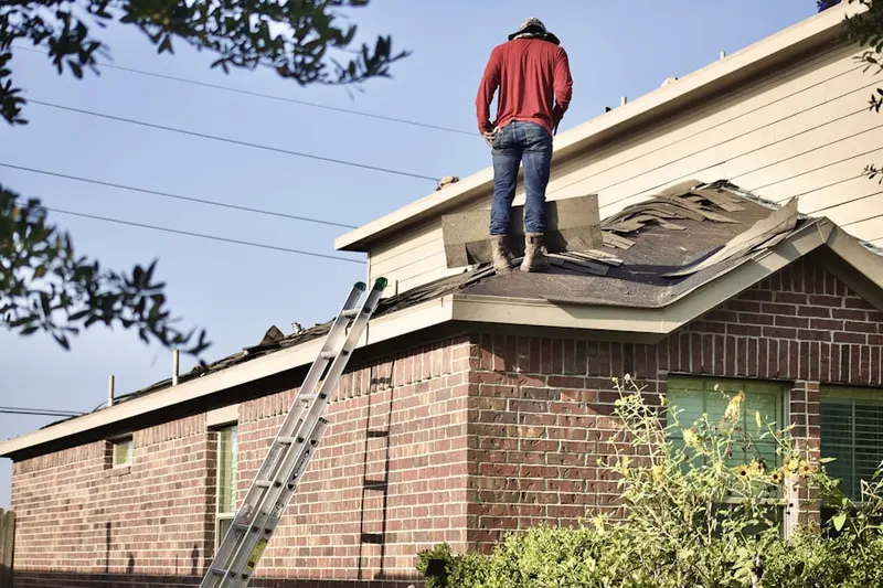 Professional roofer working on a residential roof in Blue Bell Square